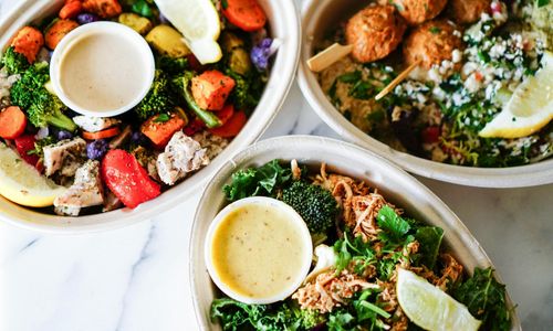 A vibrant salad with a variety of colorful vegetables like tomatoes, cucumbers, and bell peppers.